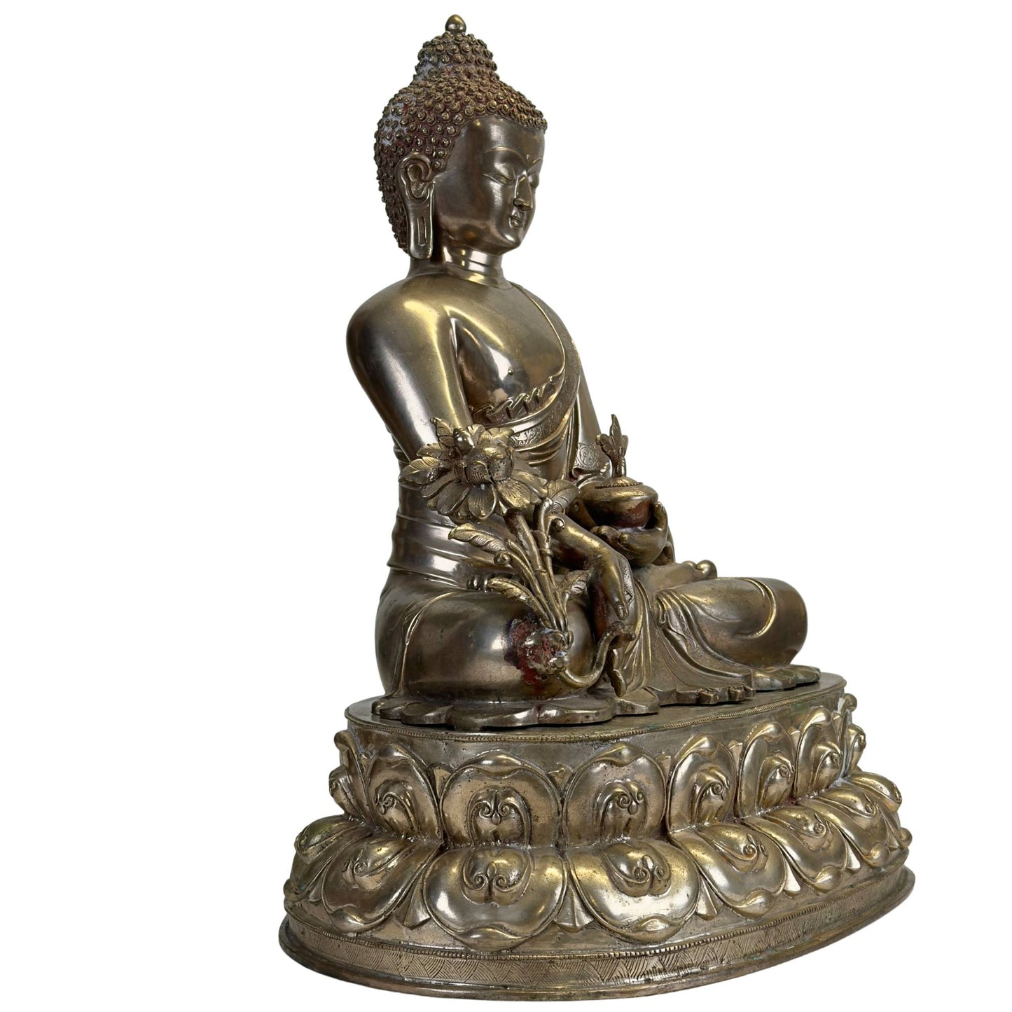 Antique Newar Bhaisajyaguru Medicine Buddha in three-quarter view with monumental double lotus throne, medicine plant, and natural patina.