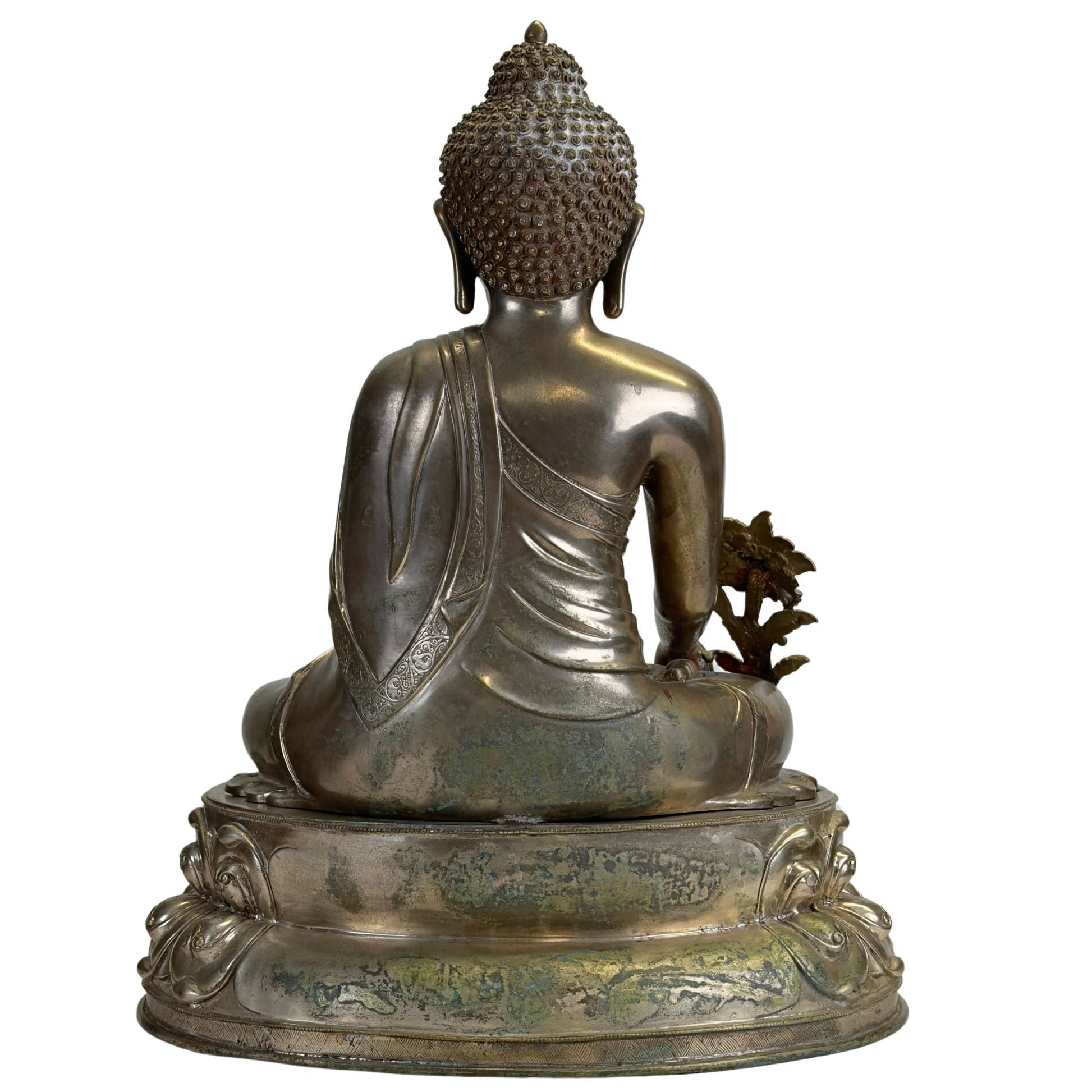 Back of an antique Newar Bhaisajyaguru in silver-plated bronze on a two-part lotus throne, with natural patina, wear, and a finely engraved monk's robe on the back.