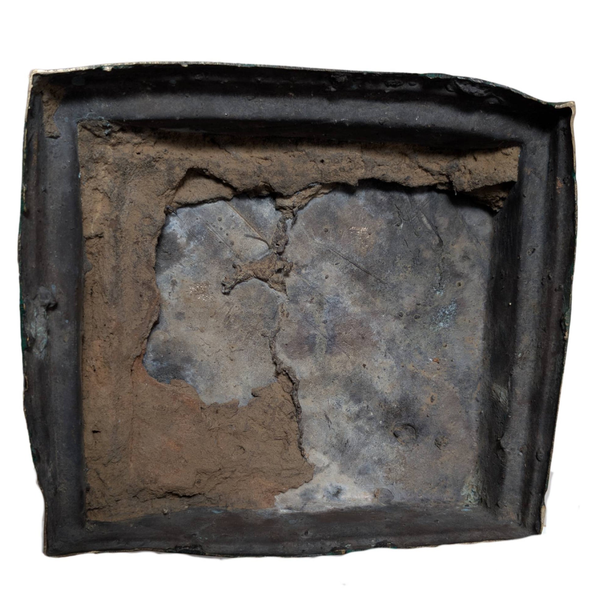 Bottom of the bronze casting with remnants of the casting core