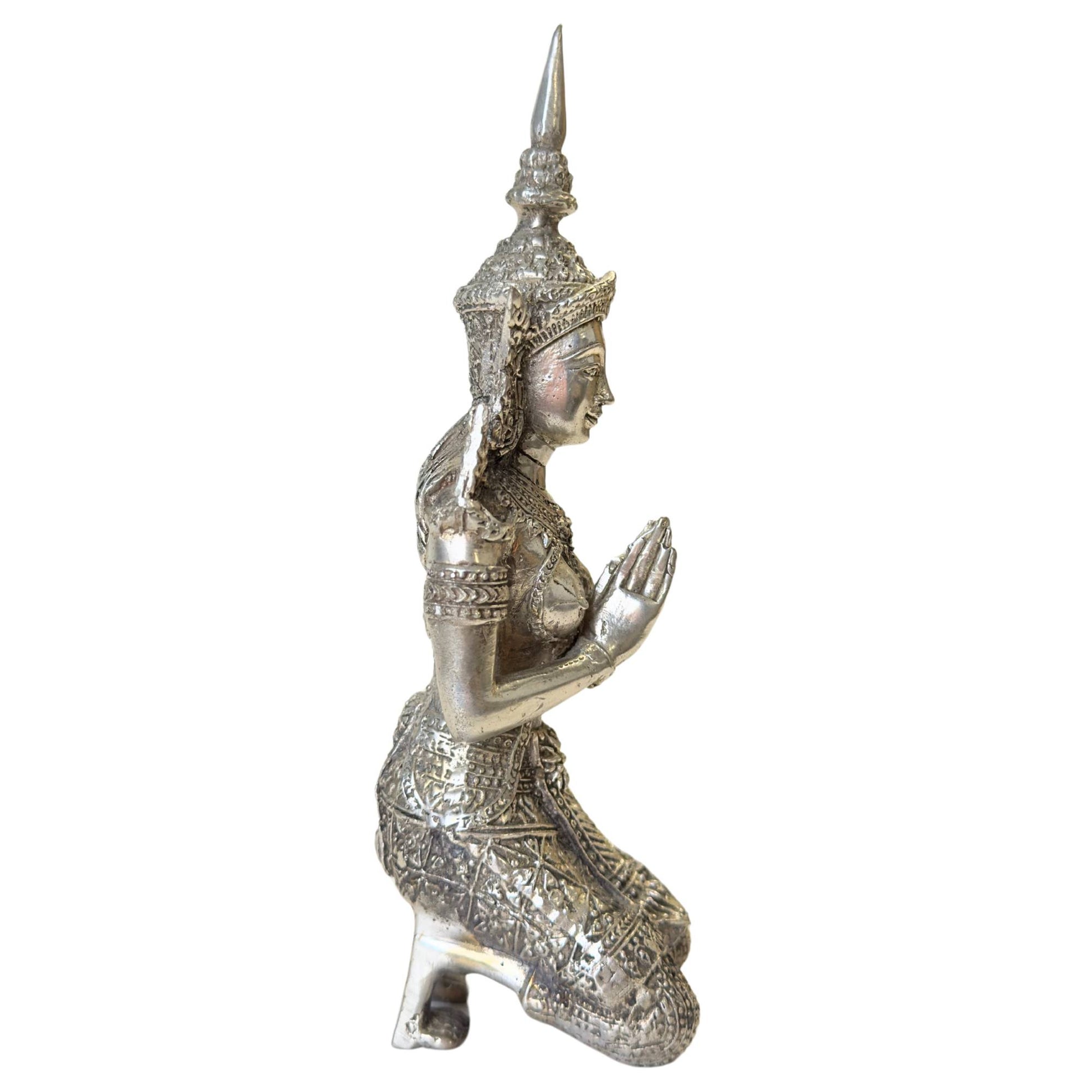 The underside of the silver-plated Thepanom statues with casting marks.
