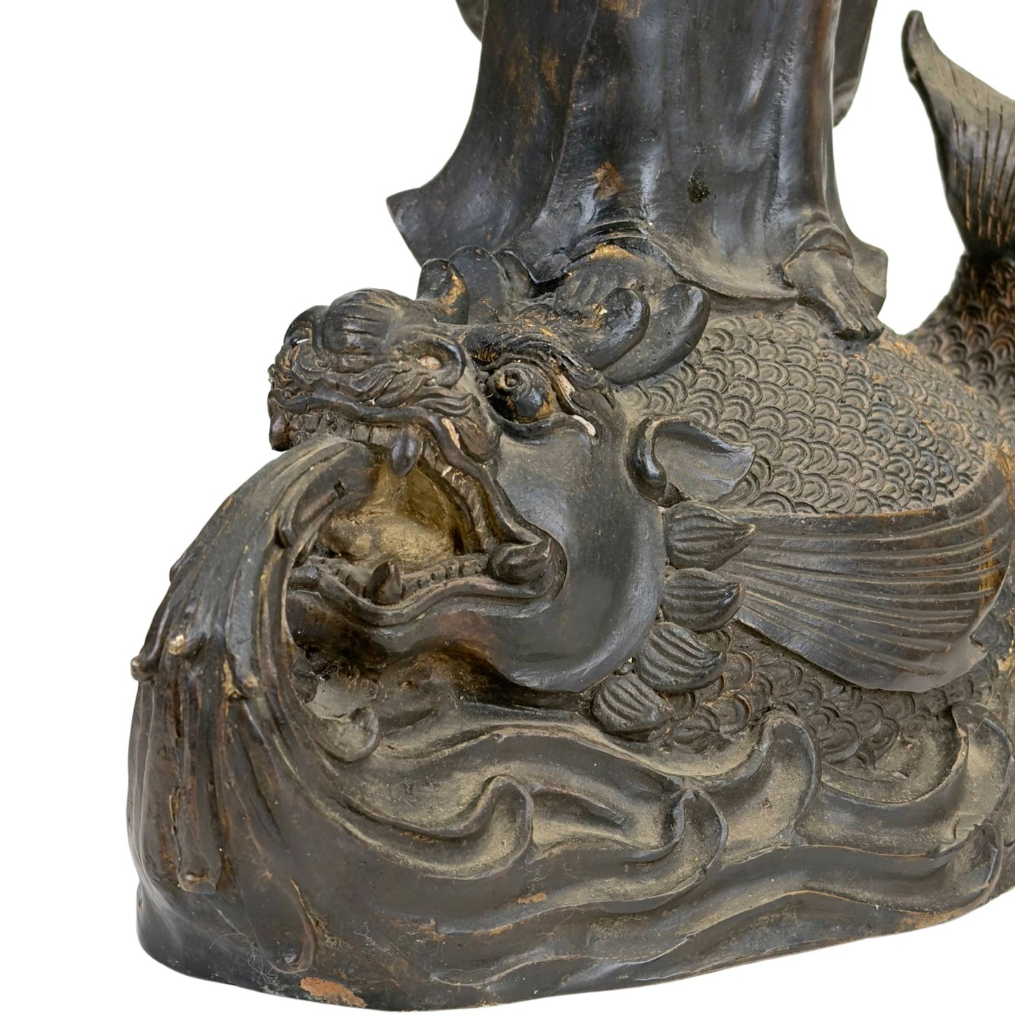 East Asian temple statue of Guanyin on a mythical water dragon with an expressive base