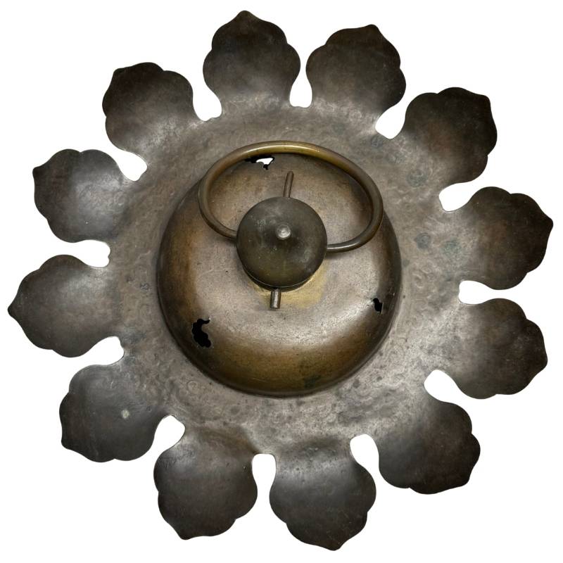 Oriental bronze temple lamp with dark patina, engraved lotus leaves, and an ornate hanging ring on top.