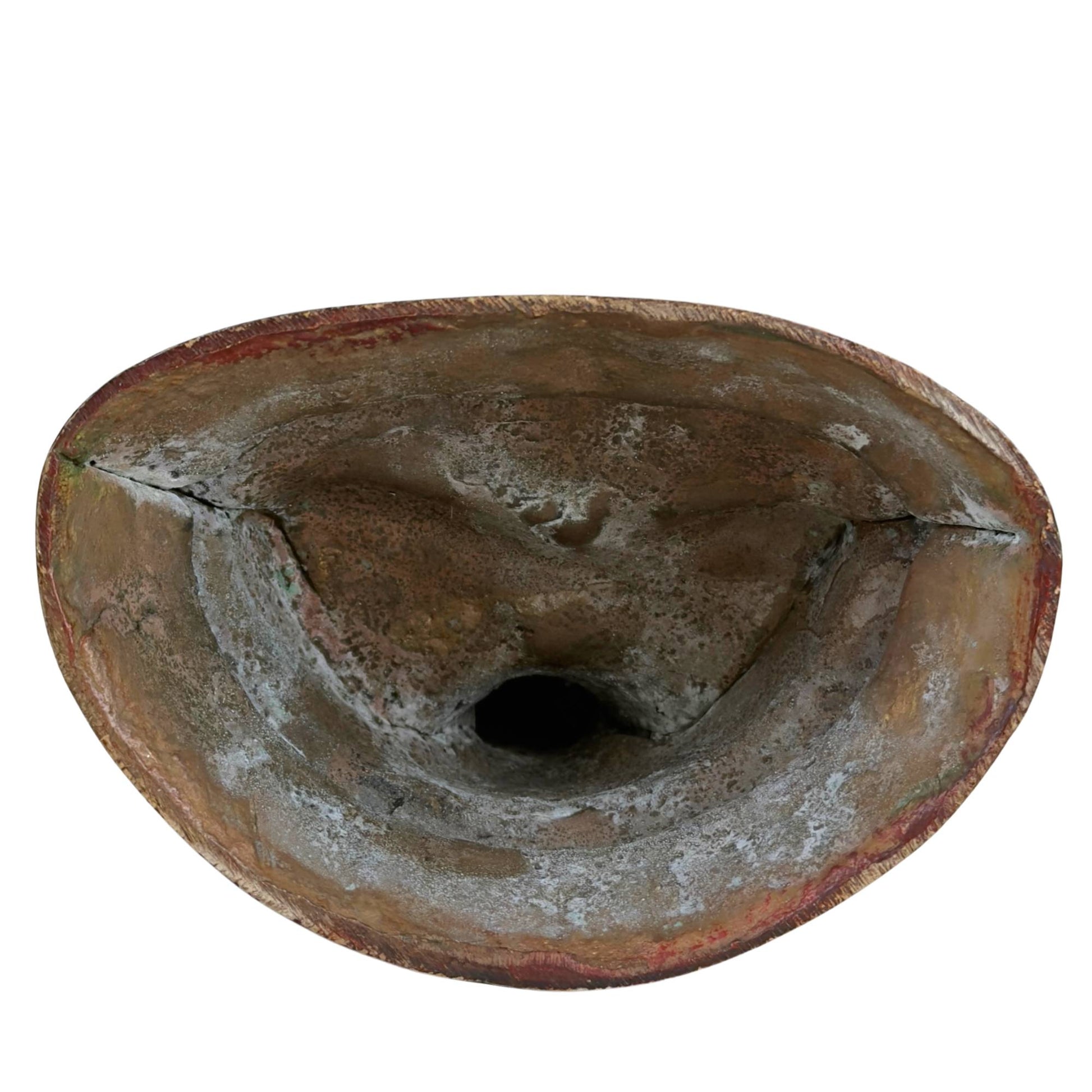 Open underside of Vajrasattva statue with rough casting texture, oxidation, and remnants of traditional bronze casting.