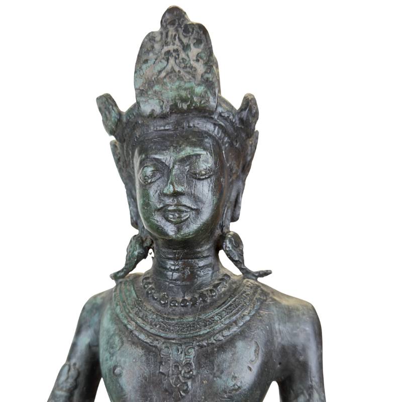 Old Asian bronze statue with dark patina and signs of use