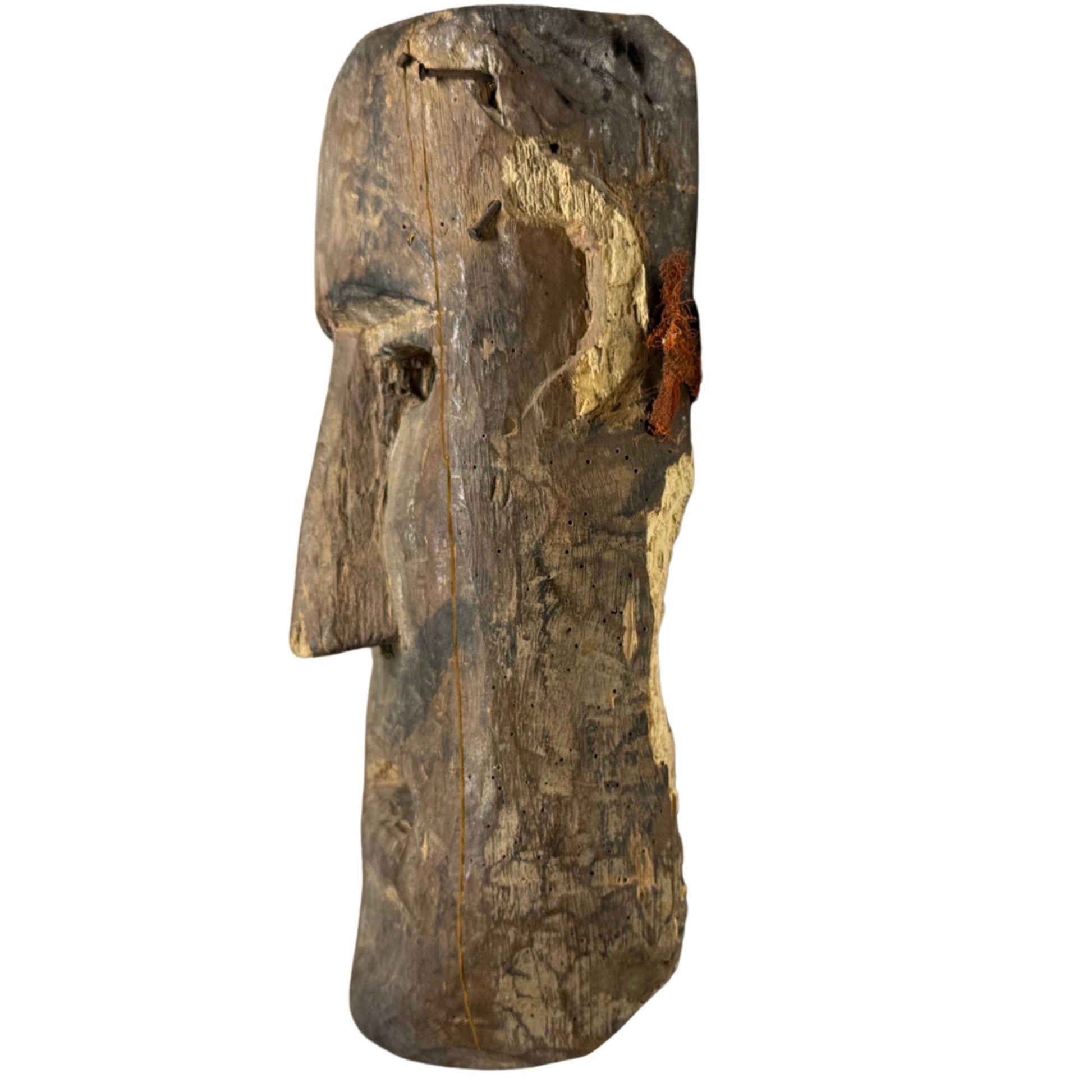 Ancient ritual mask from the Himalayas as a powerful interior object, hand-carved wood with a weathered, dark appearance