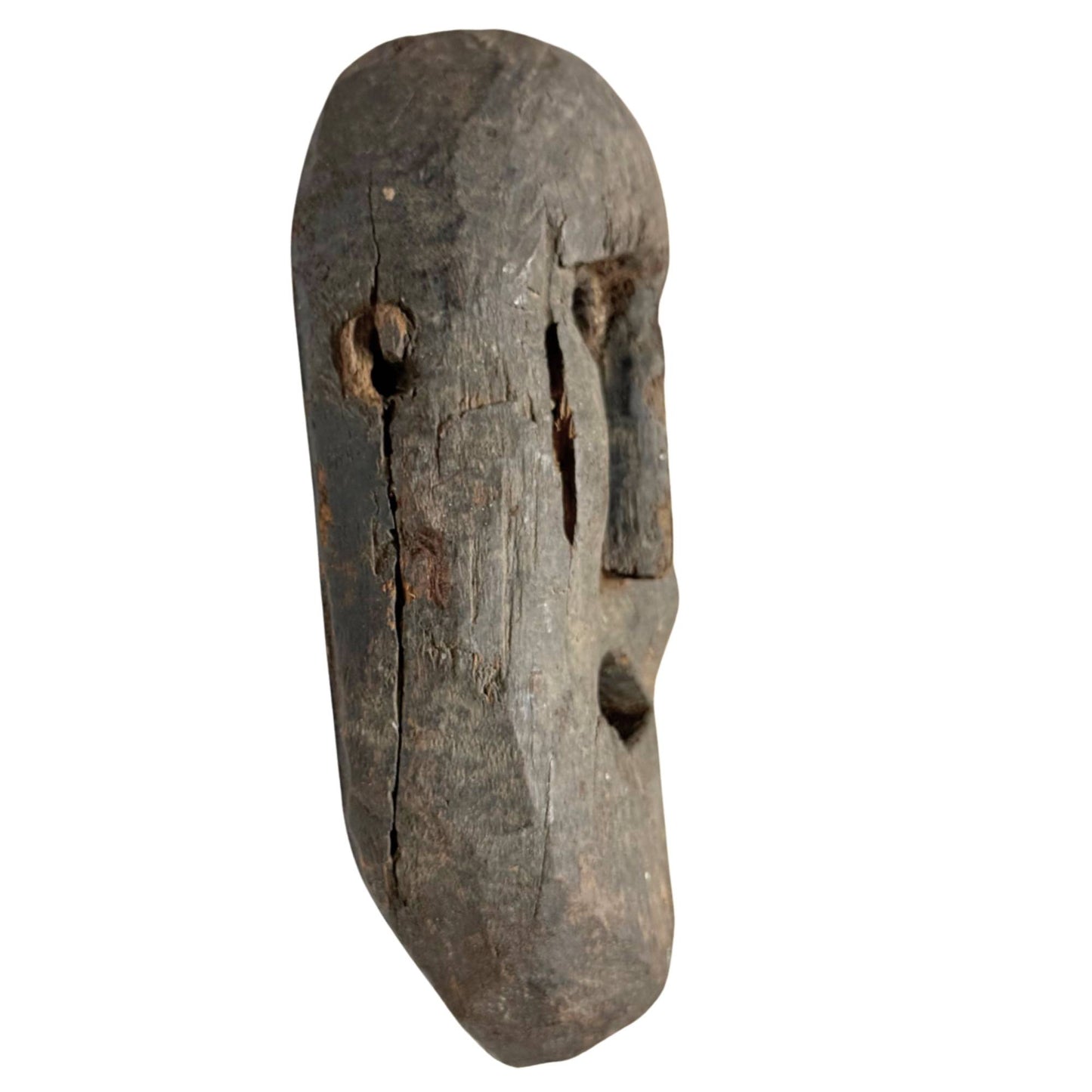 Old tribal wooden shaman mask, authentic handmade mask with weathered skin and powerful expression