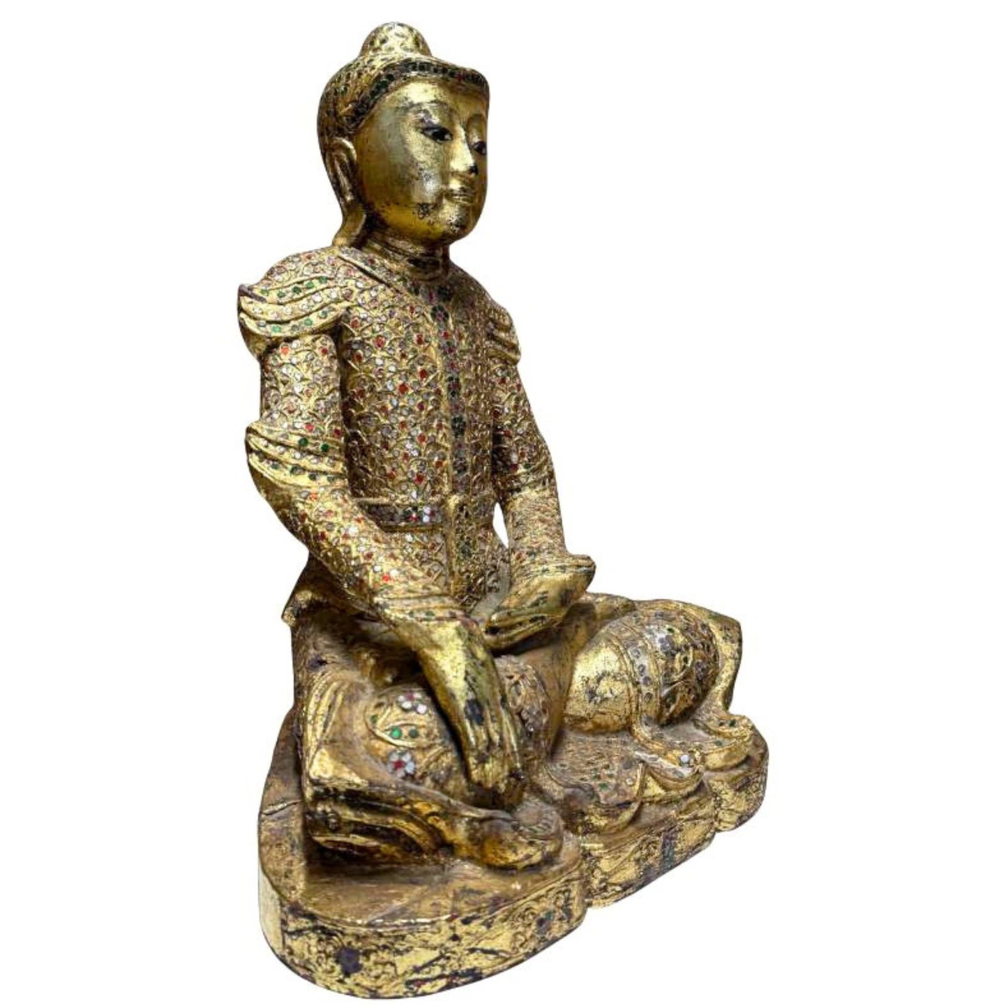 Old Burmese Buddha with gold leaf, glass decoration and spiritual appearance