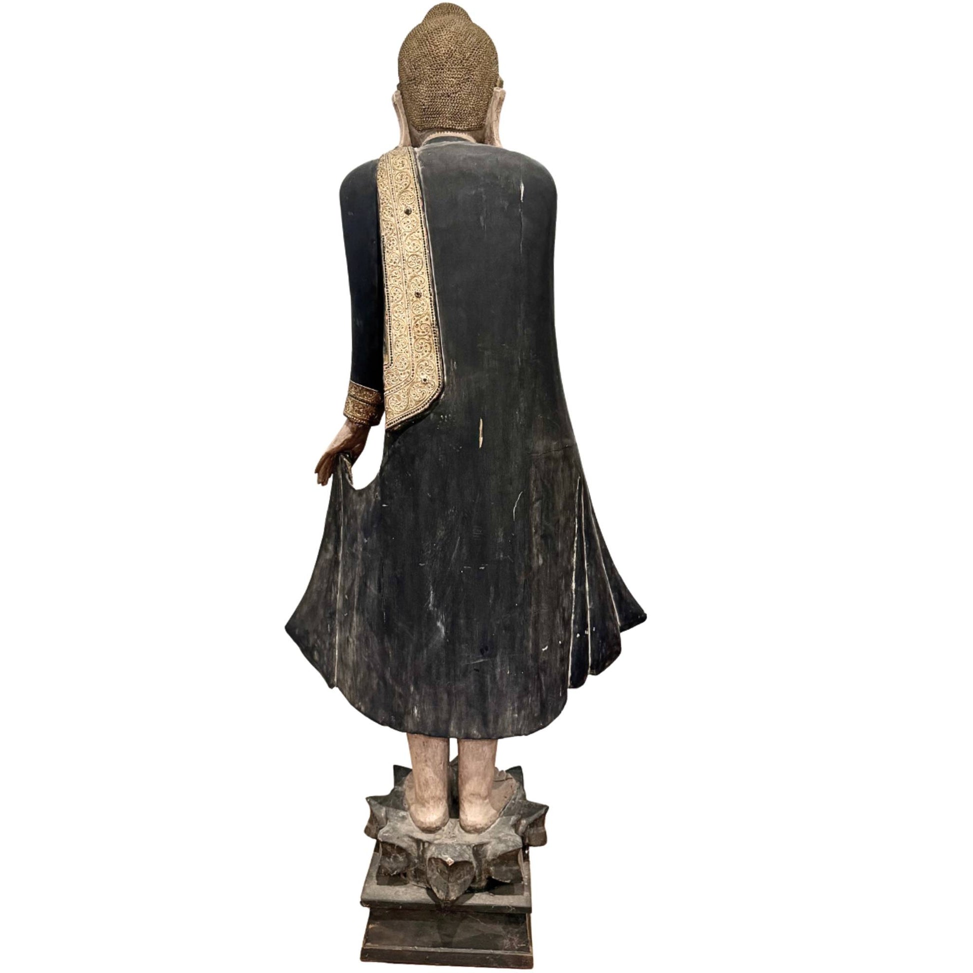 Old Burmese Buddha from temple art, 19th-century wooden statue with inlaid eyes and richly decorated robe