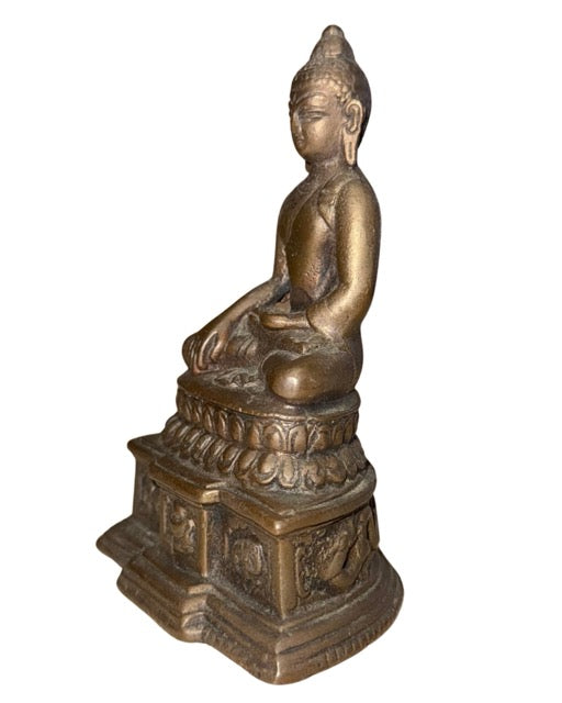 Old bronze Buddha as a collector's piece with a serene appearance and detailed base
