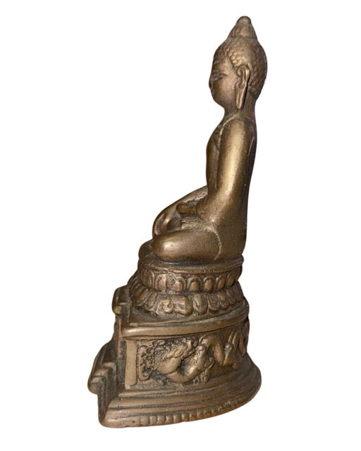 Bronze Buddha in an earth-touching posture with spiritual symbolism