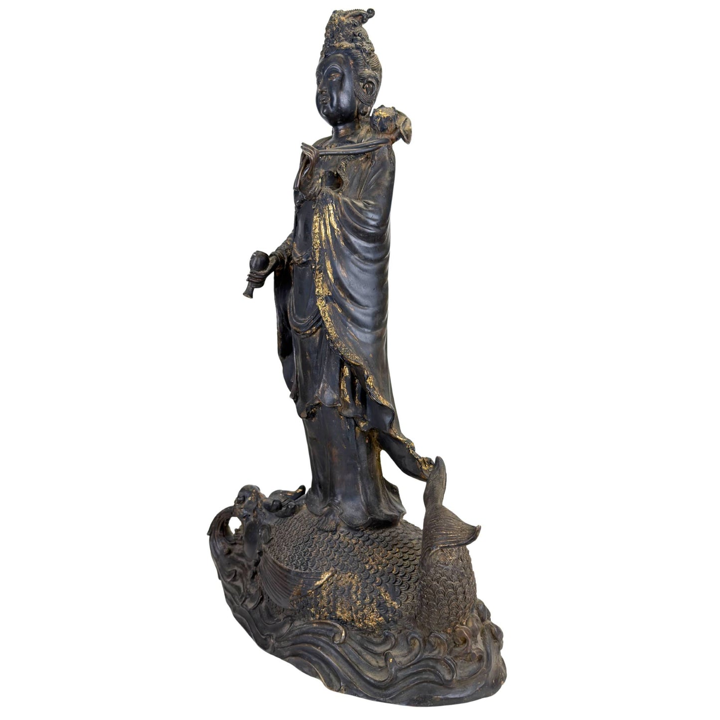 Old bronze Guanyin sculpture with richly detailed dragonfish base and visible signs of wear