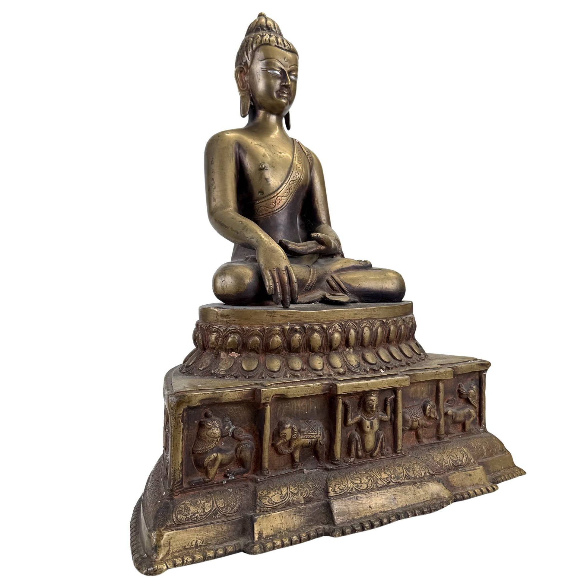 Early Himalayan Buddha with richly detailed narrative throne base and ancient temple patina