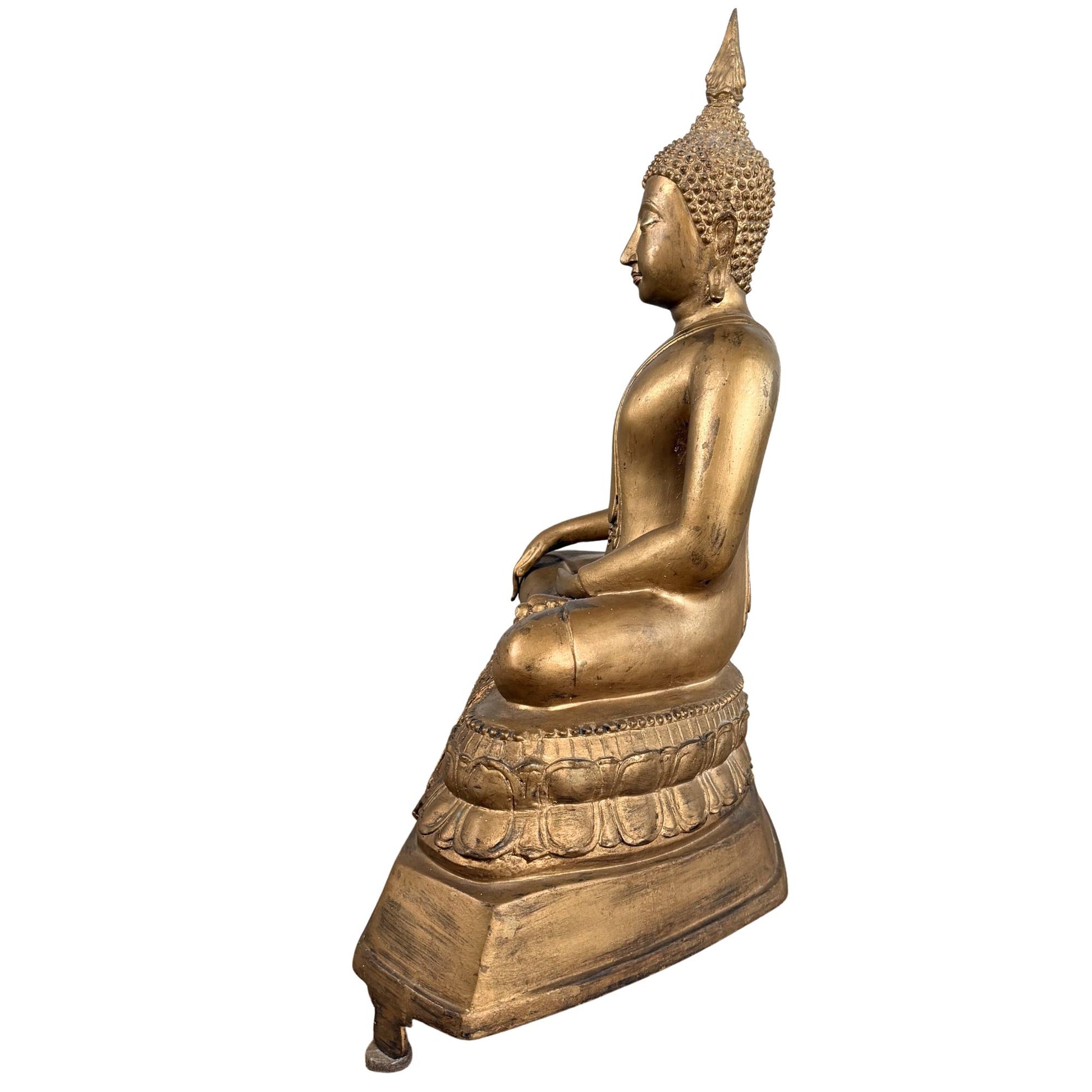 Old Thai Buddha on a richly decorated lotus base with decorative details