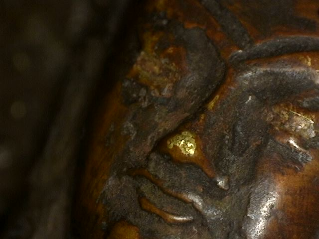 Microscope detail of oxidation on antique bronze Buddha with Dhyana Mudra