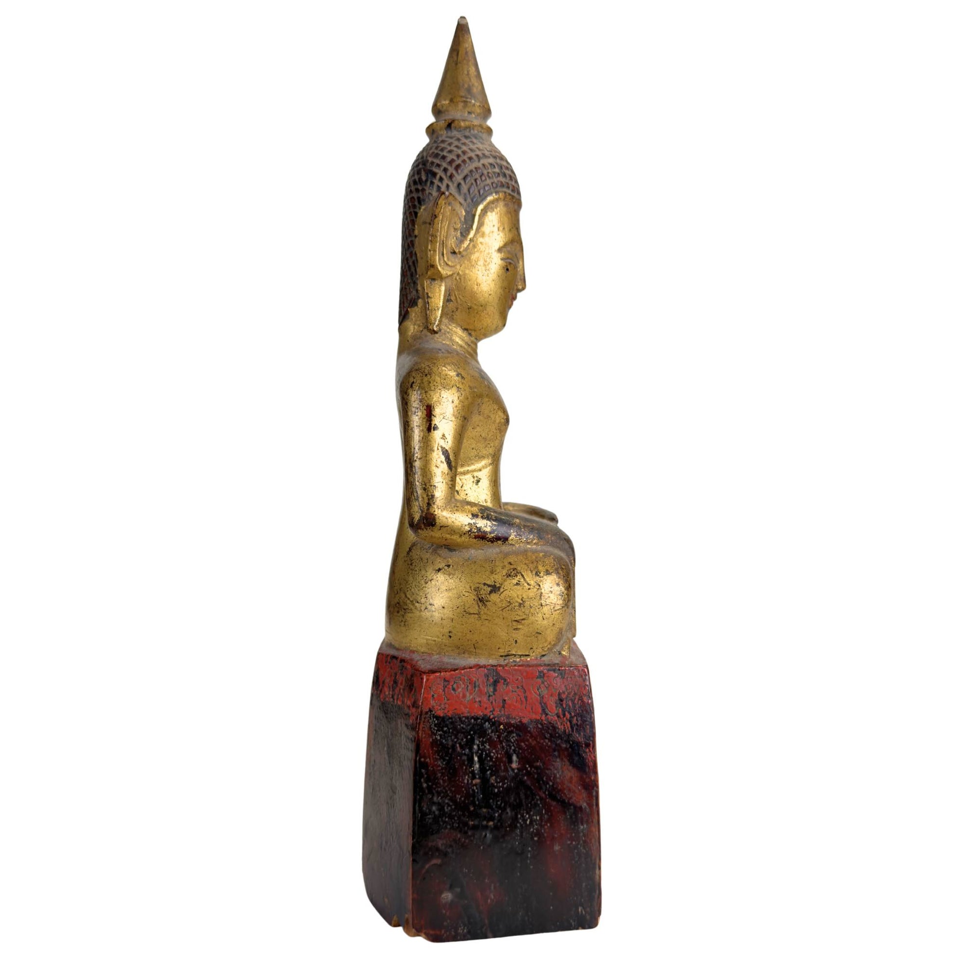 Phra Chao Mai Buddha on a tall wooden pedestal with old temple patina and gilded wear