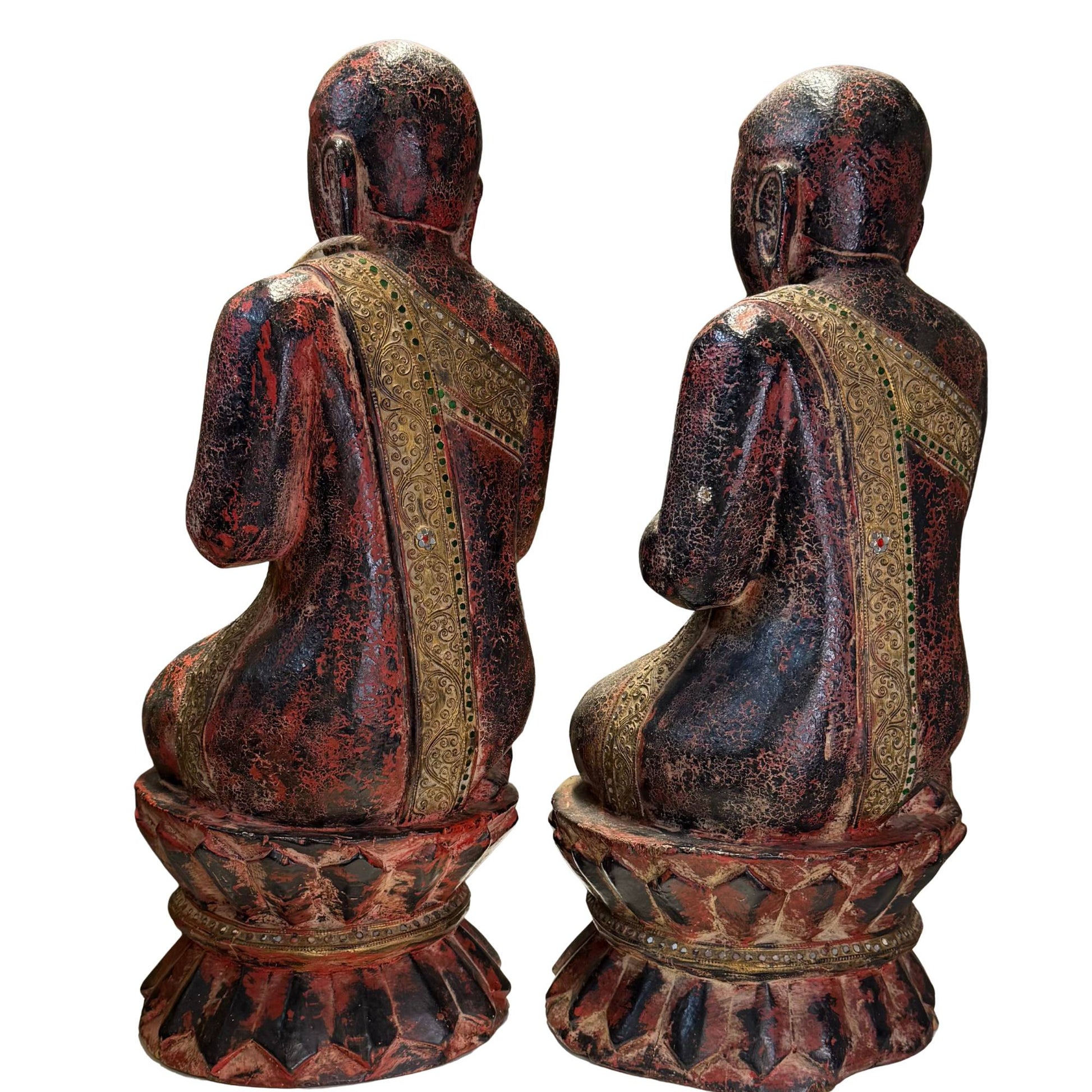 Profile shot of the refined facial features of the wooden Burmese monk.