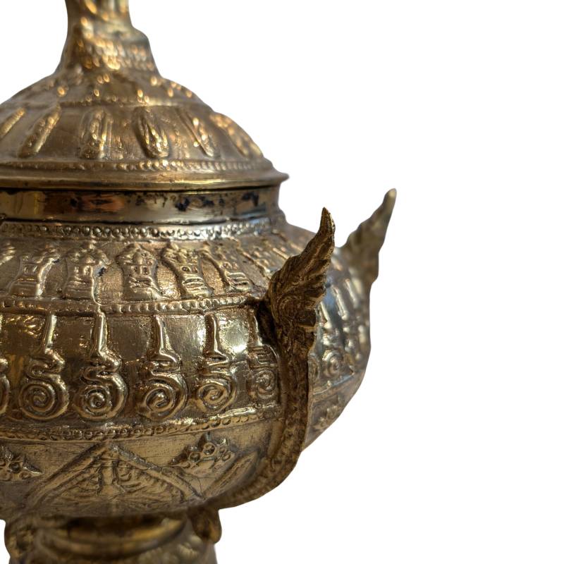 Bronze Buddhist offering bowl with detailed relief and ceremonial design.