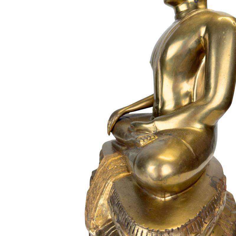 The refined folds of the sanghati (monk's robe) in heavy cast bronze.