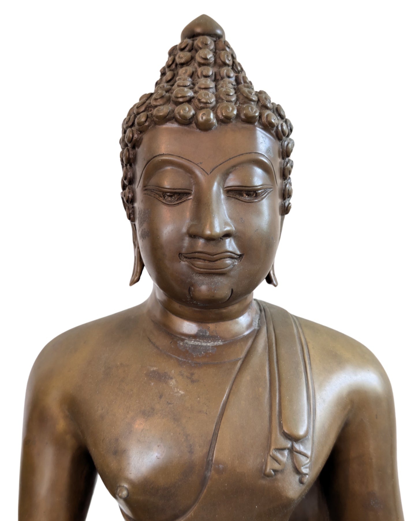 Close-up of the serene face and the flame-shaped ushnisha of the Buddha.