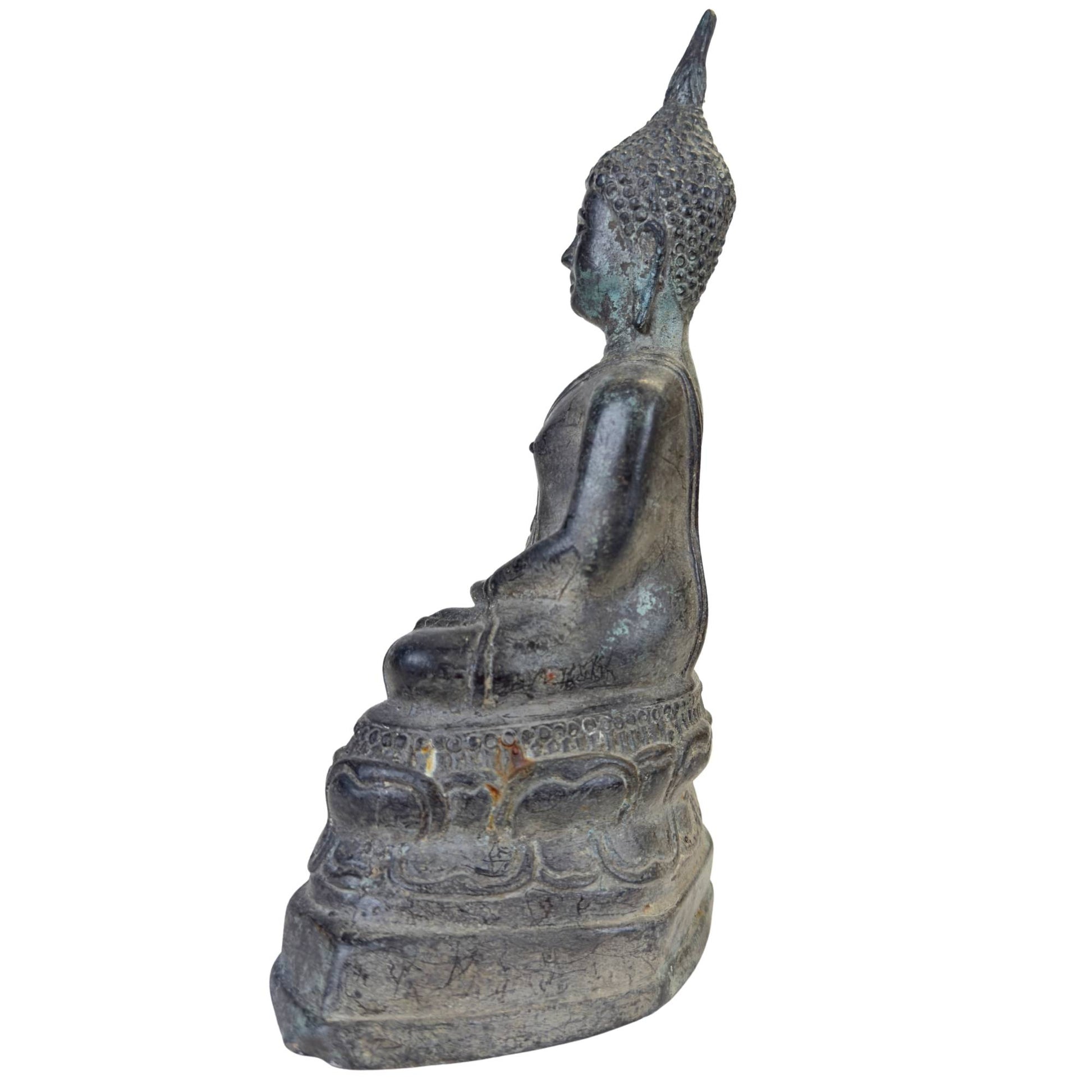 Macro shot of the serene facial features and smile of the Buddha.