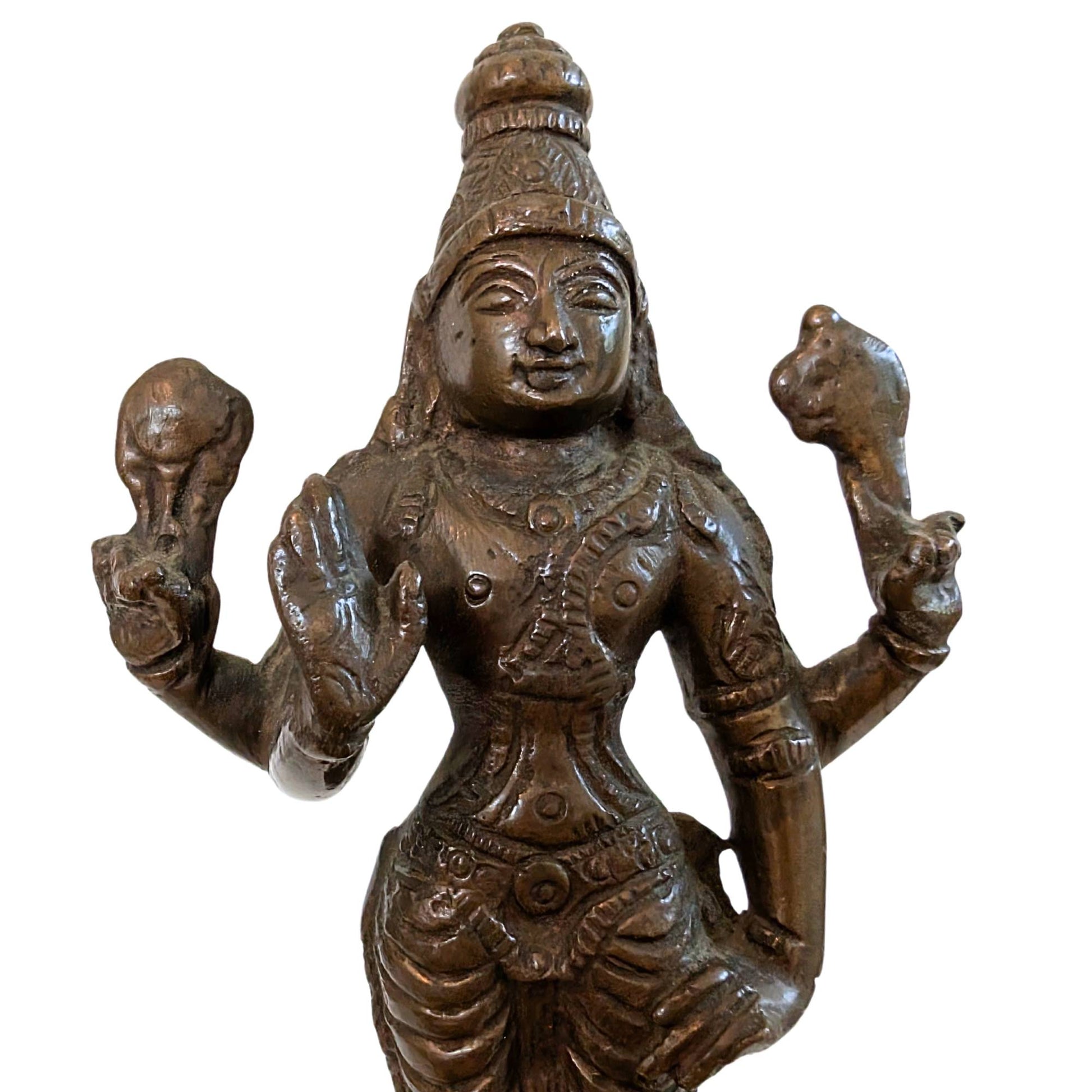 Close-up of the conch shell and discus attributes in the hands of Vishnu.