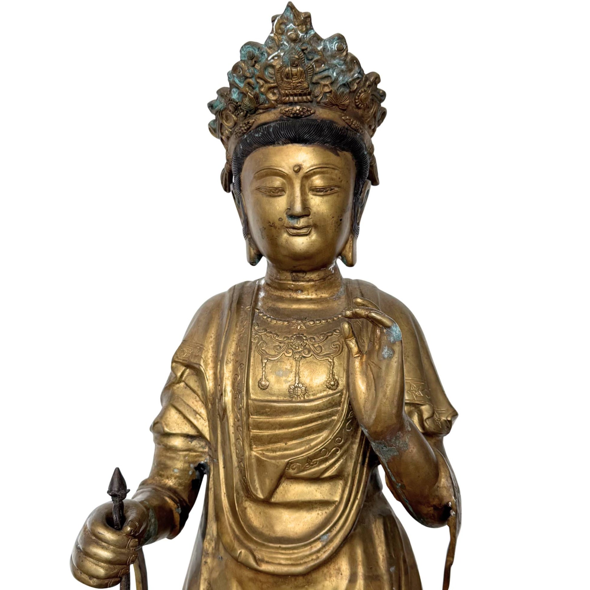 Close-up of the face and upper body, showing the male facial features of the Sho-Kannon and the layered patina of the remaining fire gilding.