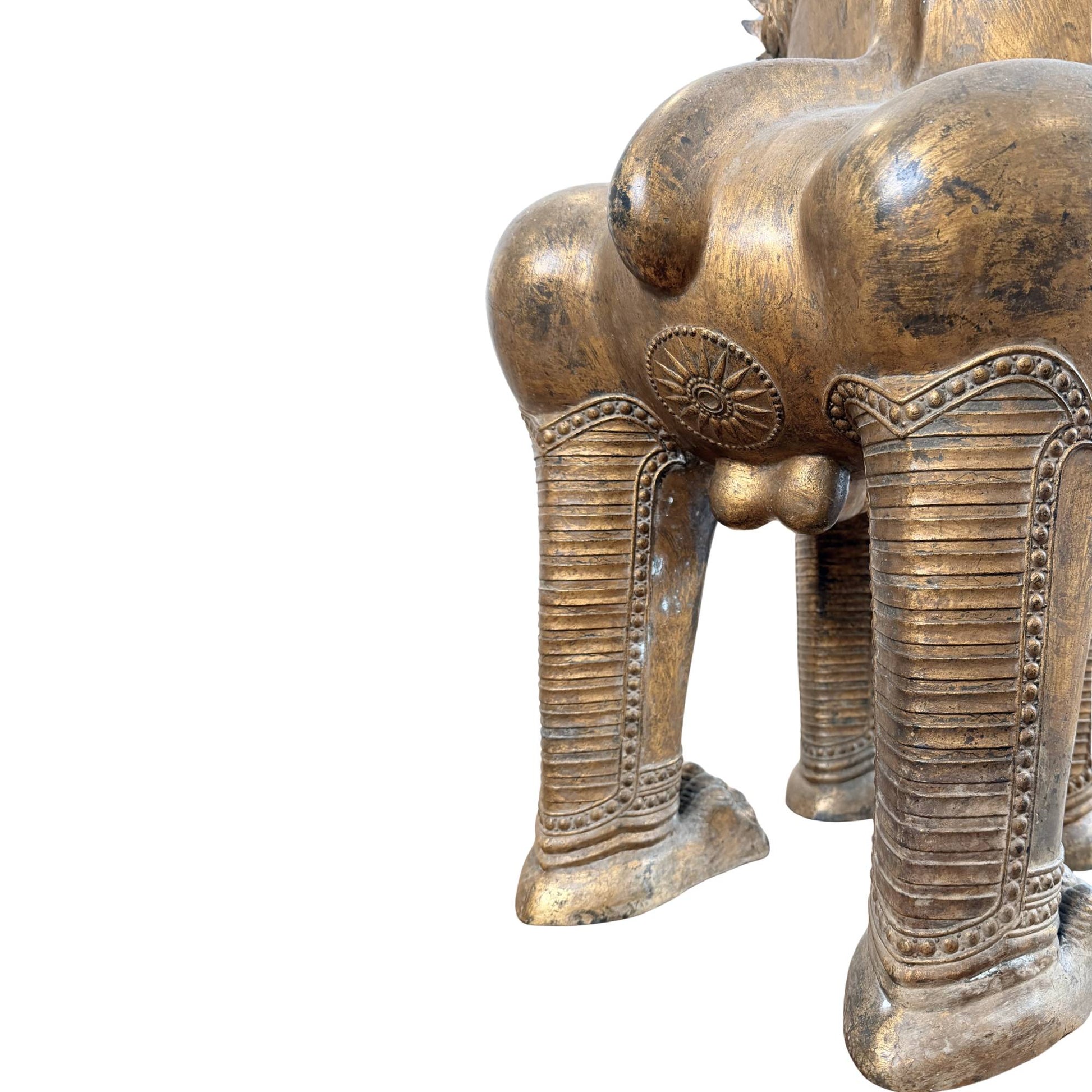 Siamese temple lion with old gilding, impressive antique guardian statue from the Thai temple tradition