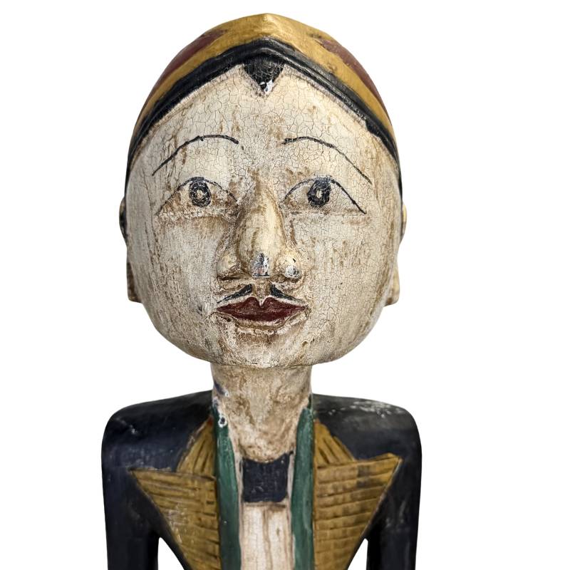 Detail of the dignified Simpuh sitting posture on solid teak.