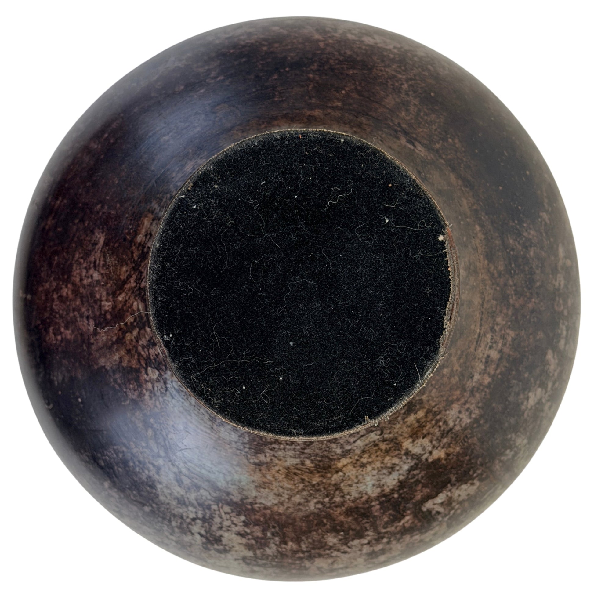 Underside of bronze vessel B with later black felt protection
