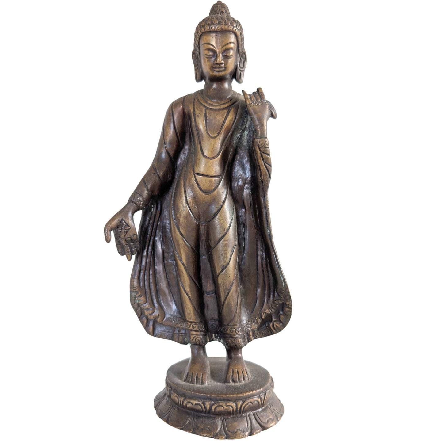 Front view of a 27.5 cm high bronze statue of the standing Buddha from Nepal.