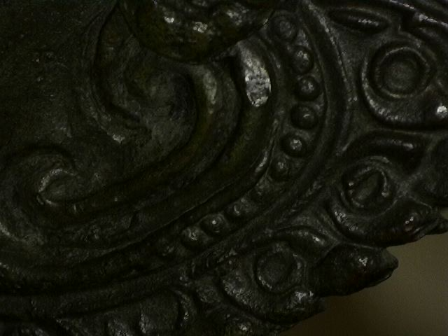 Microscope detail of ornamental work on a Thai bronze sculpture