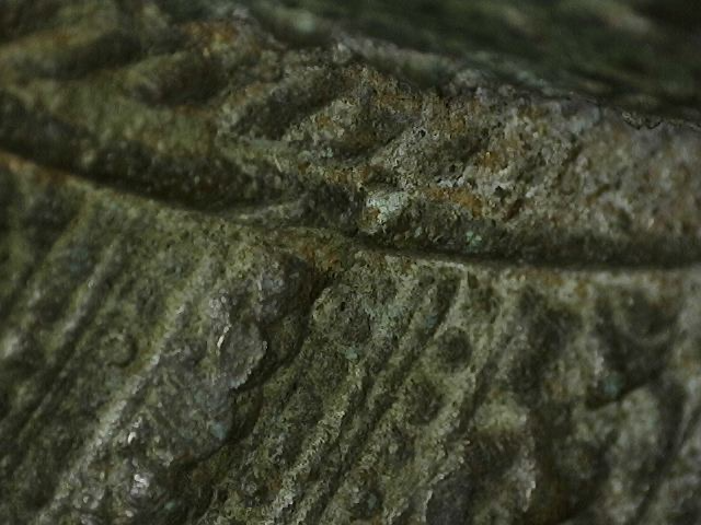 Microscope image of surface structure on antique Thai bronze statue