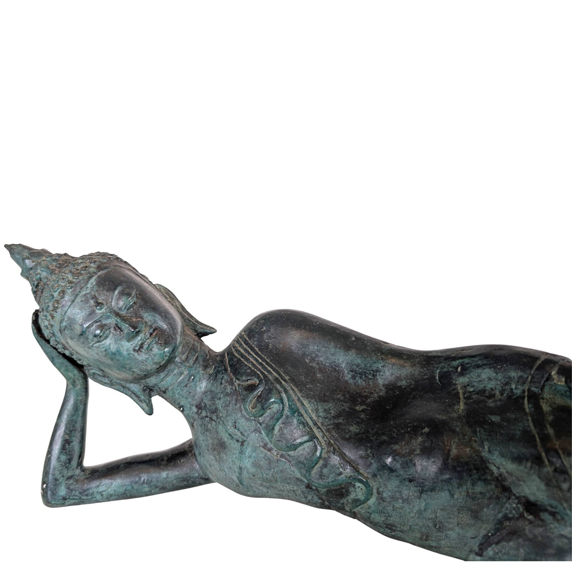 Detail of a breast ornament on an antique bronze reclining Buddha from Thailand