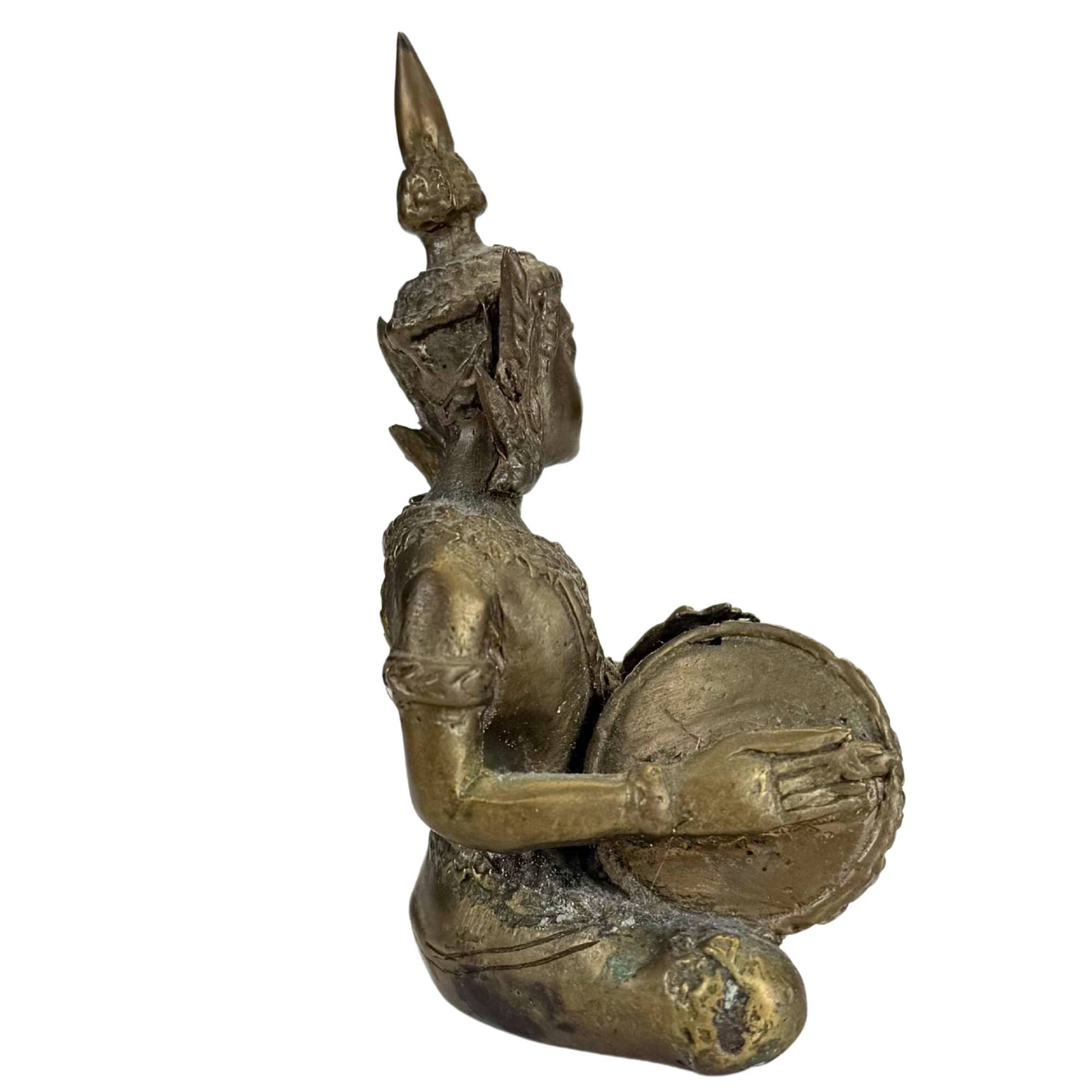 Side view of Thai bronze drummer with refined details