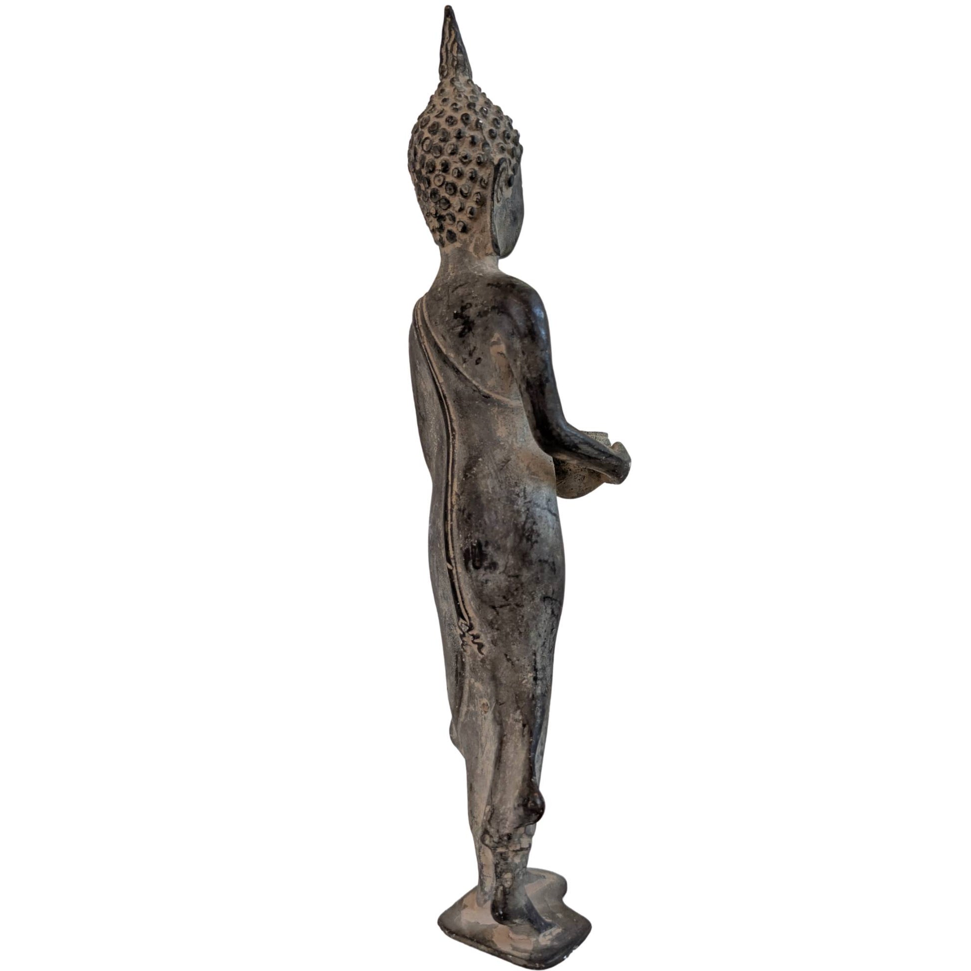 Standing bronze Shakyamuni Buddha from Thailand with alms bowl on a white background.