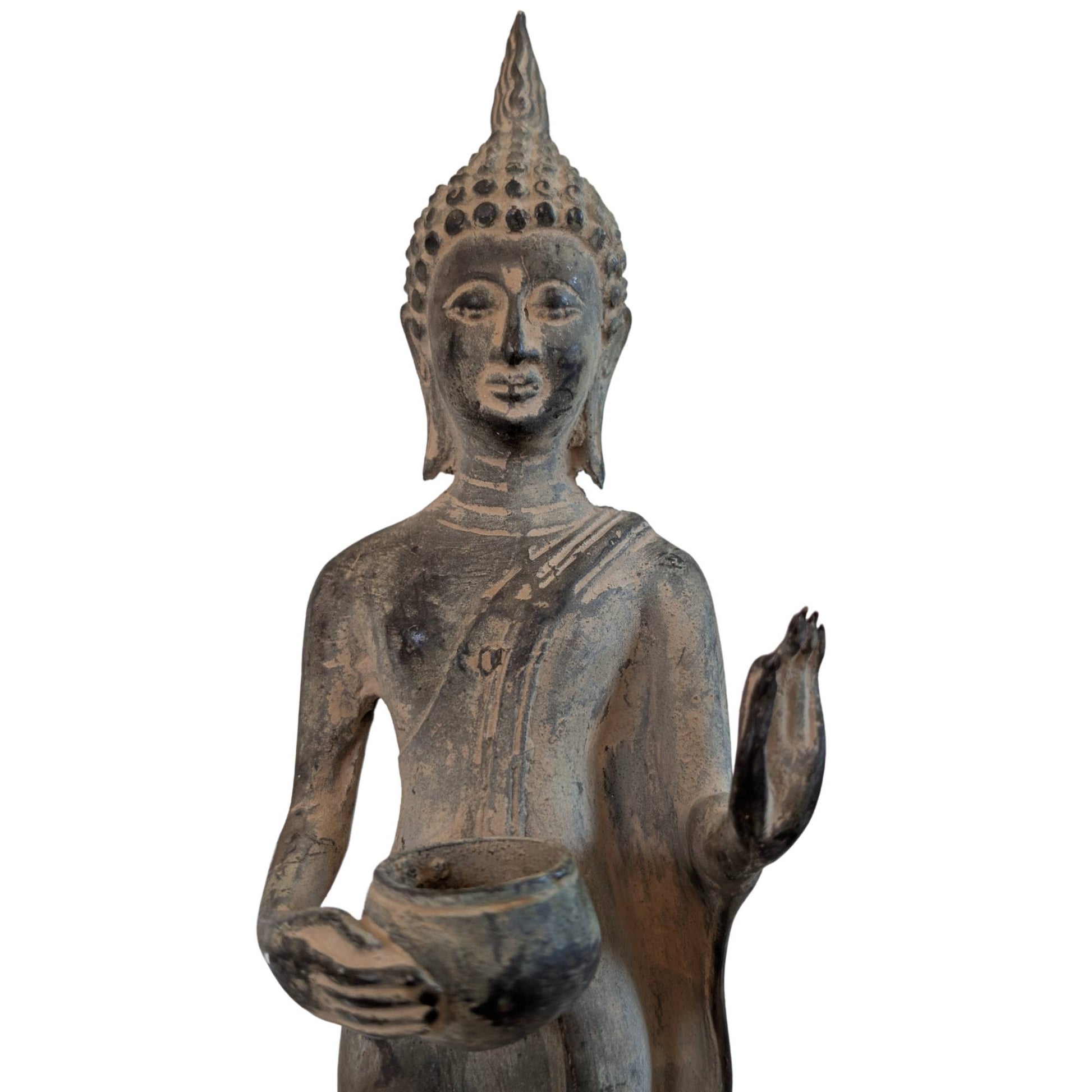 Detail of a bronze Buddha with a raised hand in a gesture of reassurance.