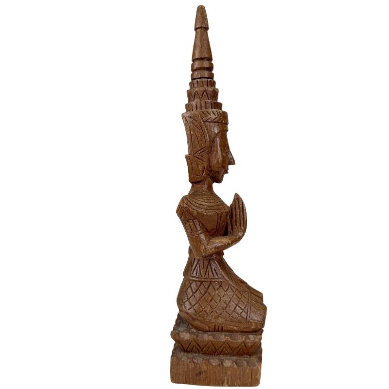 Wooden Thai temple statues with visible signs of use