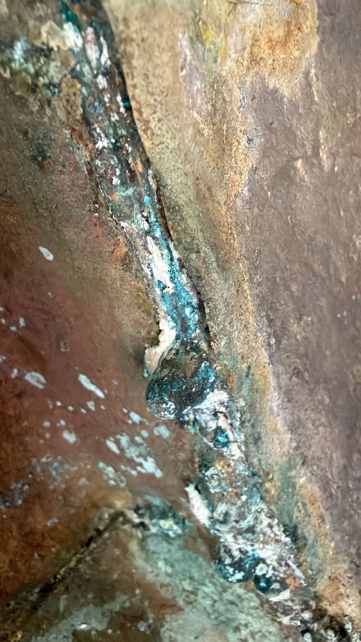 Tibetan Buddha statue with thick old gilding, dark underlayers, and signs of ritual use
