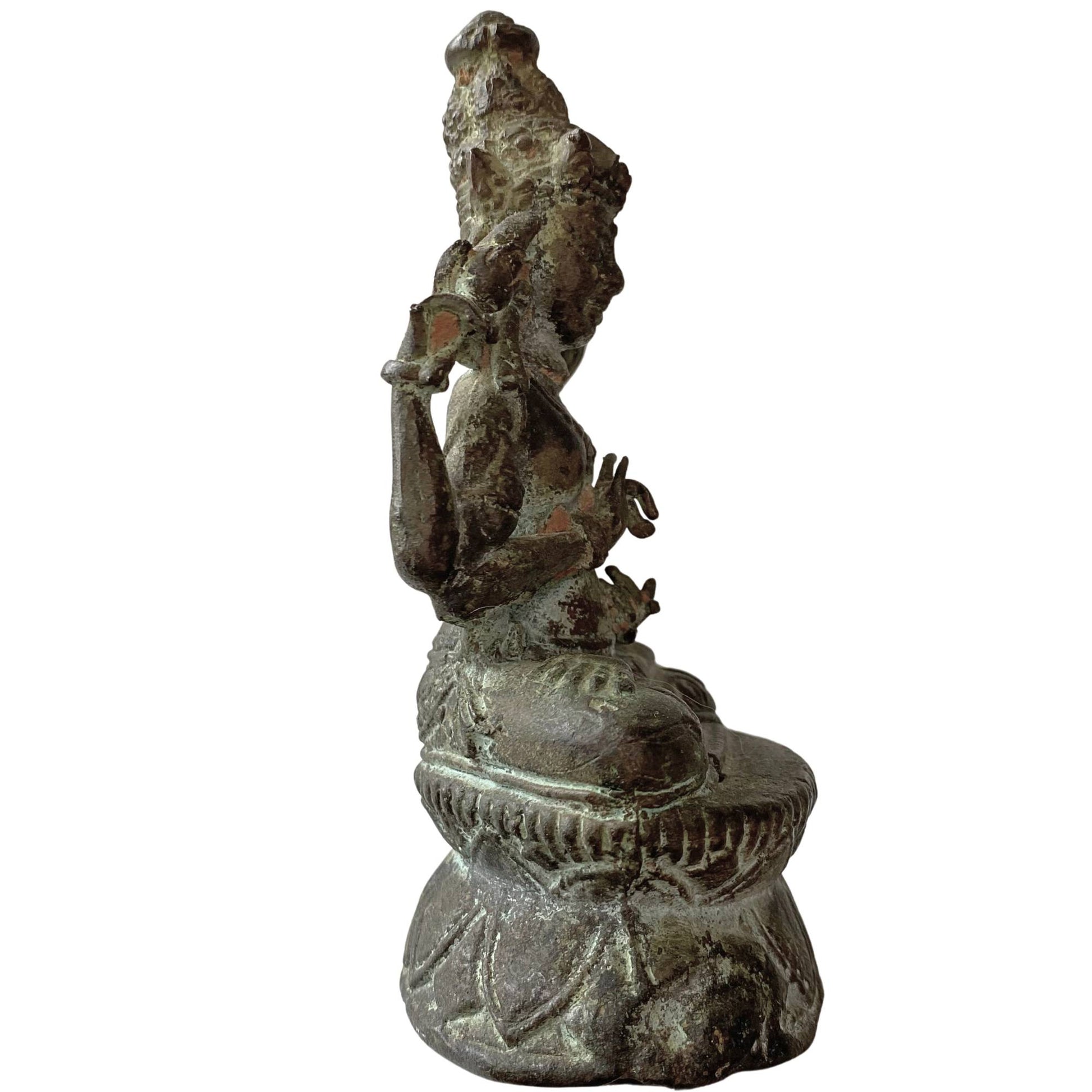 Side view of antique Tibetan bodhisattva statue with natural malachite patina