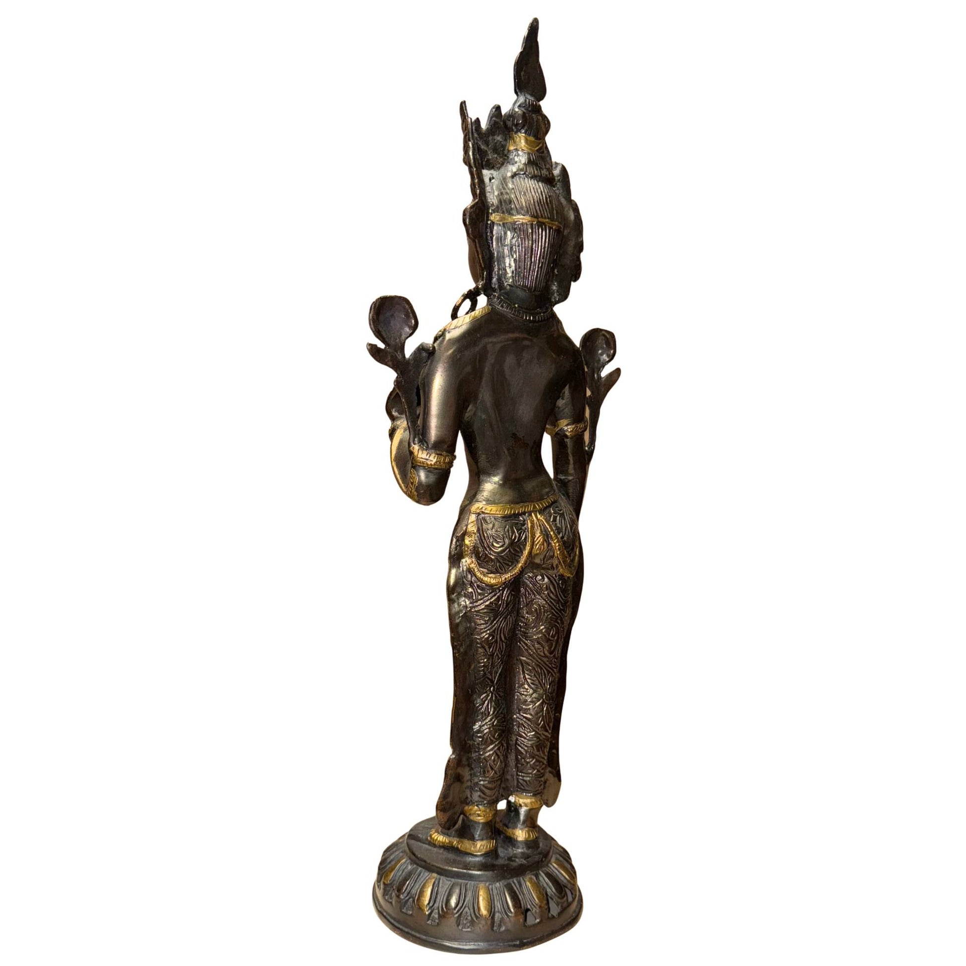 Tibetan bronze Tara with dark patina and antique gold accents in the details