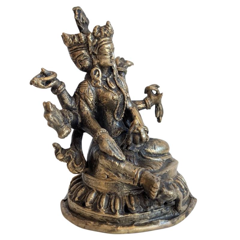 Ushnishavijaya seated on a lotus chair in Buddhist iconography