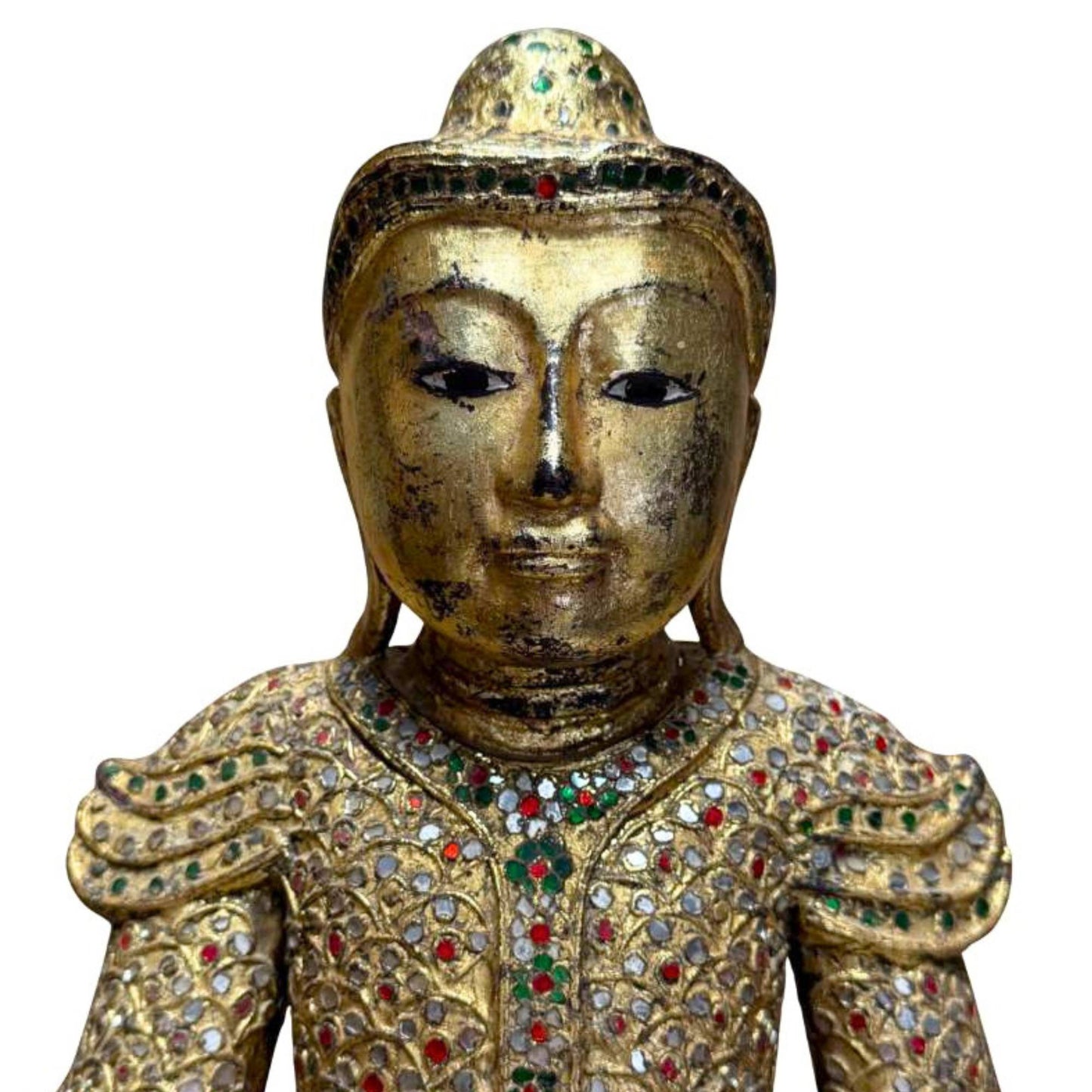 Gilded Buddha statue placed in a warm interior with a peaceful spiritual atmosphere