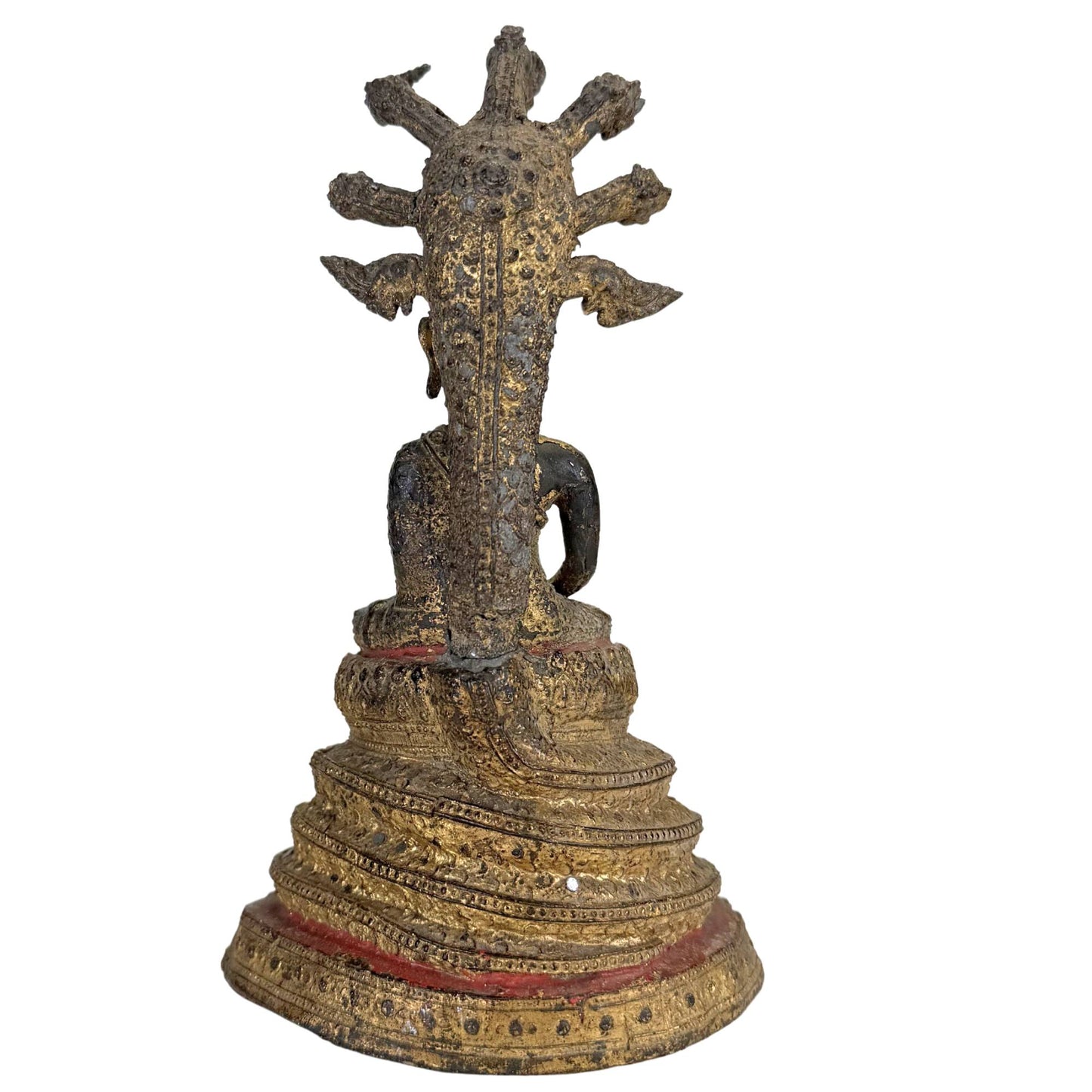 Gilded Thai Buddha statue on a traditional stepped throne with decorations