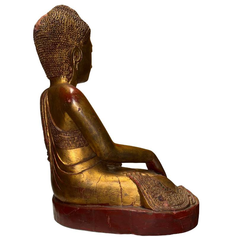 Gilded Buddha from Myanmar with visible red lacquer layer and antique wear