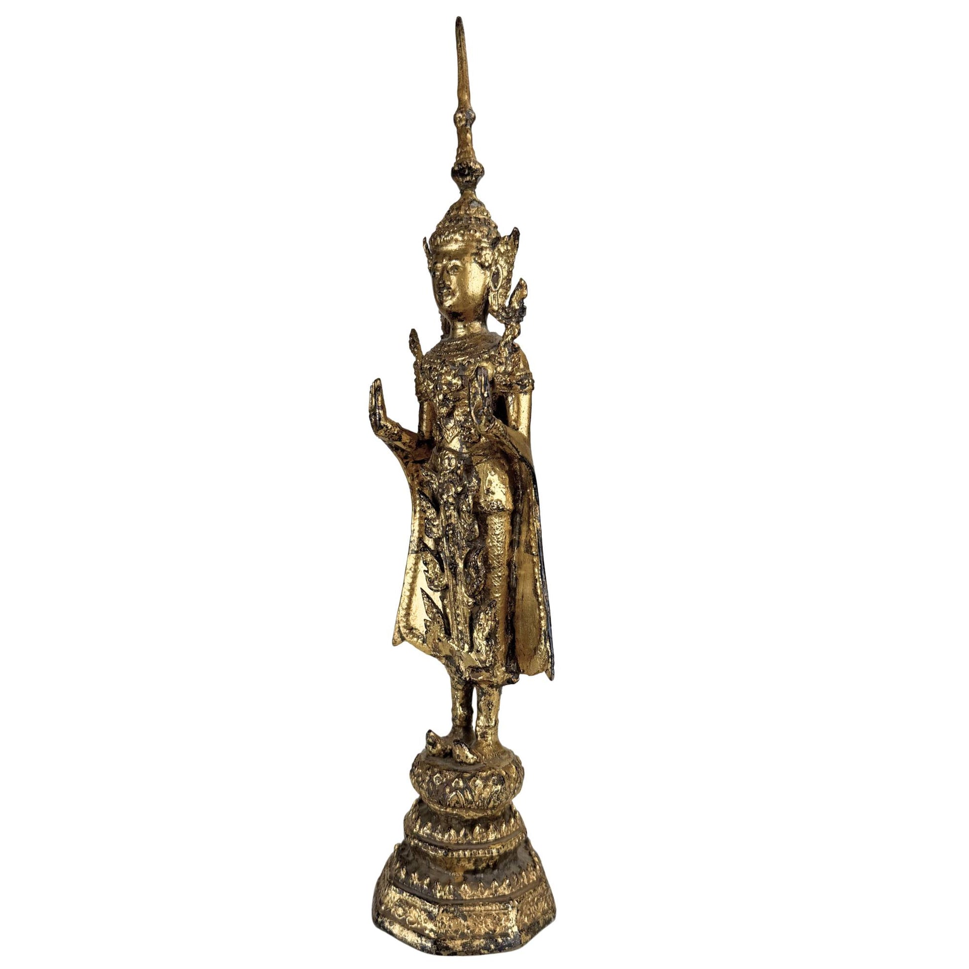 Gilded Thai Buddha on a traditional lotus base with elegant vertical design