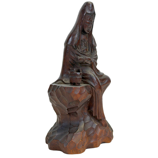Vue de trois quarts avant du côté droit, montrant la sculpture des rochers et les traits raffinés du visage du Kannon.