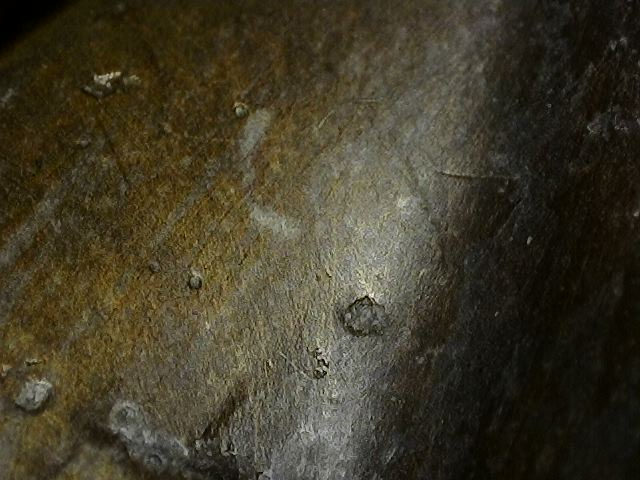 Microscopic view of cuprite and copper chlorides under fire gilding on a bronze Vishnu bust