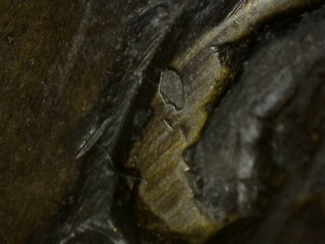 Magnification of natural oxidation and patina build-up on Khmer bronze Vishnu bust