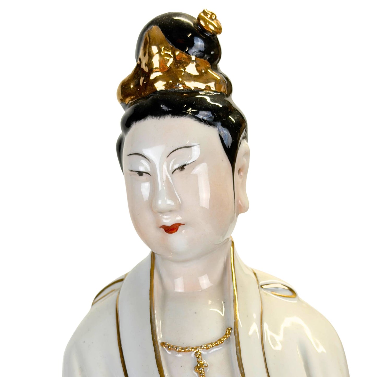 Sculpture of white porcelain with flowing robes and gold trim.