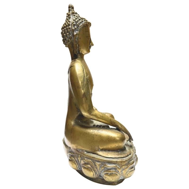 Antique fire-gilded Buddha on a lotus throne with a traditional appearance
